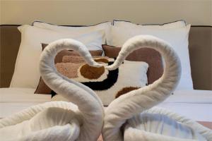 a bed with two swans shaped towels on it at Studio 2pers # Île St Louis # Bord de Seine in Paris