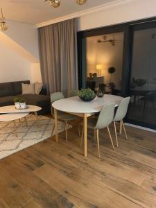 a living room with a table and chairs at Apartamenty Zuzanny in Mińsk Mazowiecki