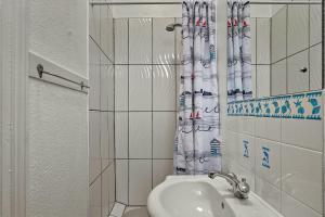 a bathroom with a sink and a shower curtain at Finest Retreats - Atherfield Apartments No 7 - Sunny Side in Paignton