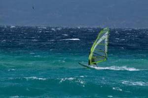 a person windsurfing in the ocean on the water at Apartment Radosevac Beach in Split