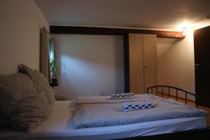 a small bedroom with a bed with a white mattress at Generations Holiday Green Views in Attendorn