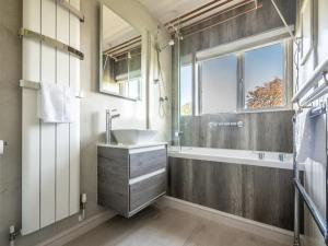 a bathroom with a sink and a tub and a window at Pass the Keys Grand country home with space for all the family in Exeter