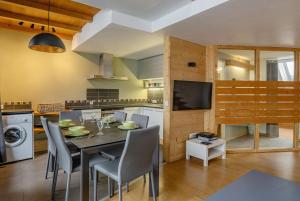 a kitchen and dining room with a table and chairs at Apartment Genevrier - Spacious Balcony with Mont Blanc Views in Chamonix-Mont-Blanc