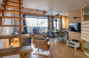 a living room with a staircase and a dining room at Apartment Genevrier in Chamonix