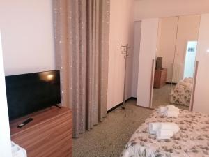 a living room with a flat screen tv and a bed at A casa di Vito in Matera
