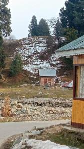a house on a hill with snow on the ground at Gulmarg View Cottage in Gulmarg