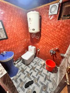 a bathroom with a sink and a toilet and a sink at Gulmarg View Cottage in Gulmarg