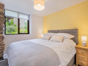 2 Bed in Haverthwaite SZ591 في Haverthwaite: غرفة نوم بسرير ابيض كبير ونافذة