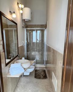 uma casa de banho com um chuveiro, um lavatório e um WC. em Le Casette nel Borgo em Borgagne