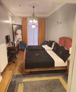 a bedroom with a large bed and a desk at Lina Hotel Taksim Pera in Istanbul