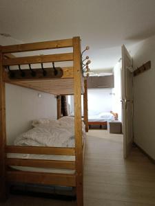 sypialnia z dwoma łóżkami piętrowymi w pokoju w obiekcie Menuires, Beau duplex 8 personnes, Ski aux pieds w Les Menuires