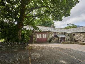 an old stone house with a red garage at 2 Bed in Buttermere SZ588 in Buttermere