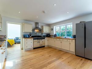 a kitchen with white cabinets and a black refrigerator at 5 Bed in Yarmouth 85286 in Yarmouth