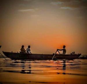 a group of people in a boat on the water at Shree Madhvam AC Dormitory in Varanasi