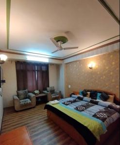 a bedroom with a large bed and a ceiling at Hotel Mehar Srinagar in Srinagar