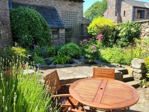 a wooden table and chairs in a garden at 2 Bed in Kirkby Stephen SZ144 in Kirkby Stephen