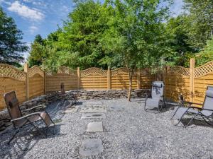 a backyard with chairs and a wooden fence at 2 Bed in Staveley SZ590 in Staveley