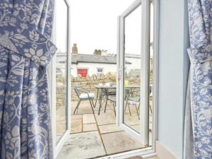a view from a window of a patio with a table and chairs at 4 Bed in Cockermouth SZ037 in Cockermouth