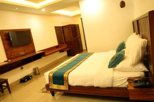 A bed or beds in a room at Panna Tiger Resort- Riverside Property