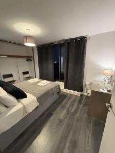 a bedroom with a large bed and a table and chairs at 2BR/2BA Gem with Private Balcony in London