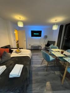 a hotel room with two beds and a living room at 2BR/2BA Gem with Private Balcony in London
