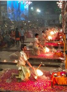a group of people performing a ritual in a temple at Shree Madhvam AC Dormitory in Varanasi