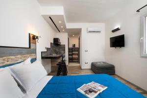 a bedroom with a blue bed and a desk at OlbiaLoft in Olbia