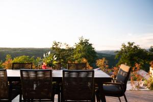 a table and chairs on a patio with a view at Luxury Villa Callista near Labin with kids playground, fitness and heated pool in Ružići +34 photos