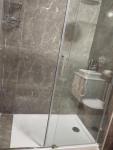 a bathroom with a shower with a sink and a toilet at Pearl Apartments in Sliema