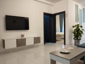 a living room with a tv on a wall at Pearl Apartments in Sliema