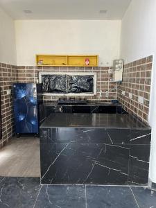 a kitchen with a black counter top in a room at The River Side Resort & Farm in Noida