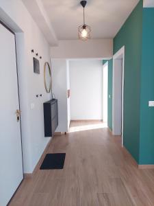an empty room with a hallway with a large window at BeHOME in Tirana