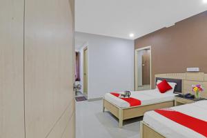 a hotel room with two beds and a mirror at Hotel Padmini Near Lakdikapool Metro Station in Hyderabad