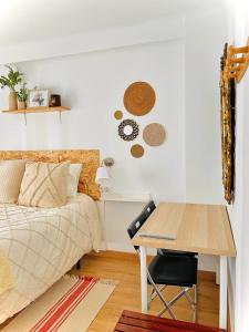 una camera con letto, scrivania, letto e tavolo di Alojamiento Calma a Hospitalet de Llobregat