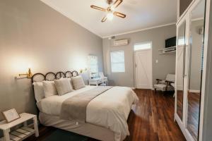 a bedroom with a large bed and a ceiling fan at SchoemansRus in Riebeek-Wes