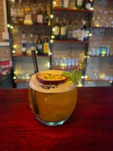 a drink with an orange slice on a table at Khmer Cozy in Battambang