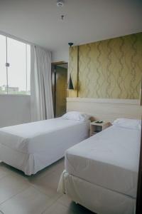 Tempat tidur dalam kamar di Mako´s Hotel