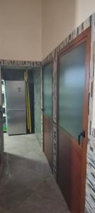 a room with two doors and a refrigerator at DAR LAAZIZA in Meknès