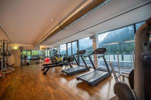 a gym with treadmills and exercise equipment in a building at MyTirol in Biberwier