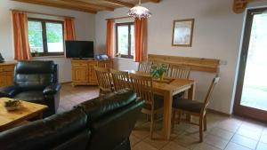 a living room with a couch and a table and chairs at Ferienhaus Bauer in Kurort Oberwiesenthal