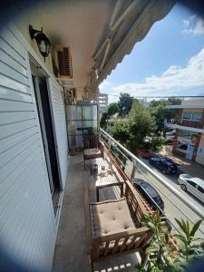 a balcony with chairs and a view of a street at Apollo Apartment Athens/Airport in Spata