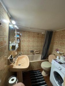 a bathroom with a sink and a toilet and a tub at Apollo Apartment Athens/Airport in Spata