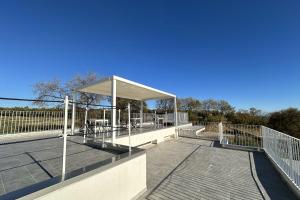 a boardwalk with a canopy on top of a building at Villa Caravaggio Comfort e Relax in Rocca San Giovanni