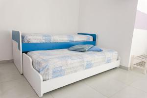 a bedroom with two bunk beds in a white room at Villa Caravaggio Comfort e Relax in Rocca San Giovanni