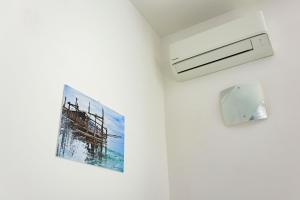 a picture of a pier hanging on a wall at Villa Caravaggio Comfort e Relax in Rocca San Giovanni