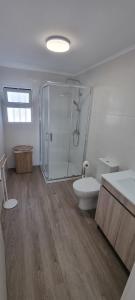 a bathroom with a shower and a toilet and a sink at Casa do Pescador in Lagoa +11 photos