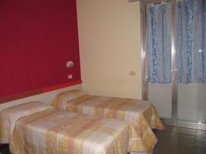 Postel nebo postele na pokoji v ubytování Hotel Majestic