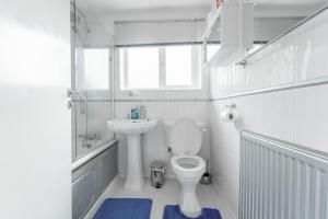 a white bathroom with a toilet and a sink at Contractors - Family - City Centre - NEC in Birmingham