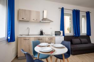 a kitchen and a table and chairs in a room at OlbiaLoft in Olbia