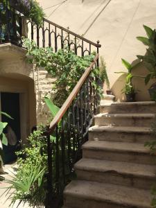 a set of stairs leading up to a building with plants at Apartment Eleonora in Senj